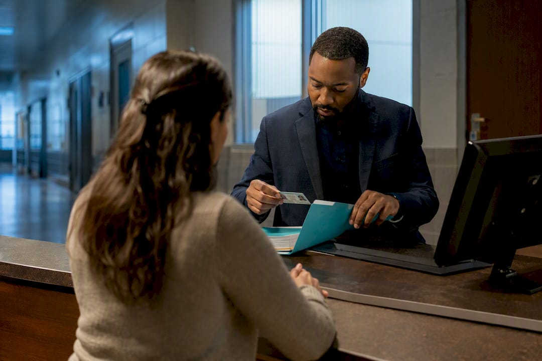 Bail agent assisting applicant at release counter