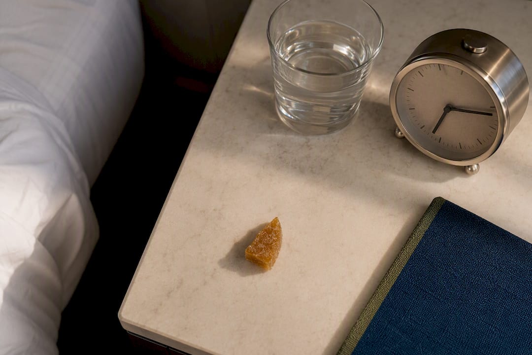 Small edible portion beside water and clock