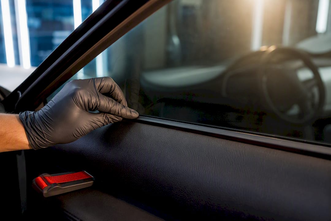 Installer checking ceramic film on car glass