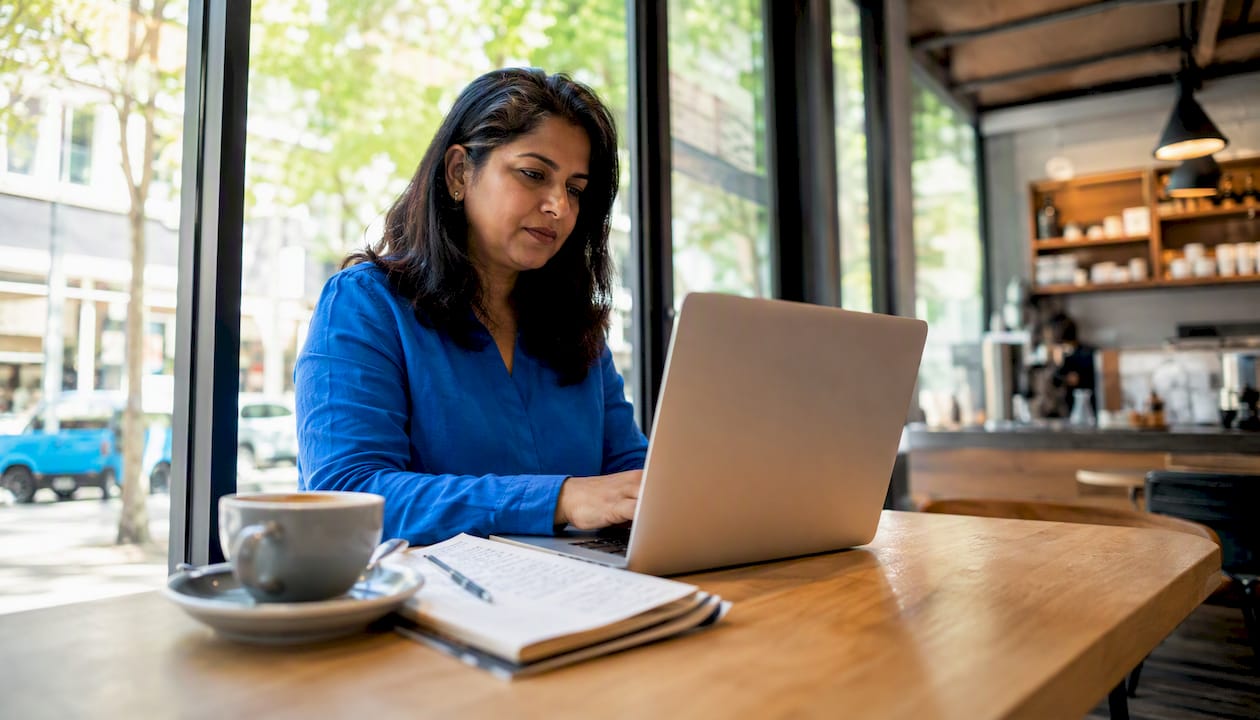 Woman comparing car sale websites at home
