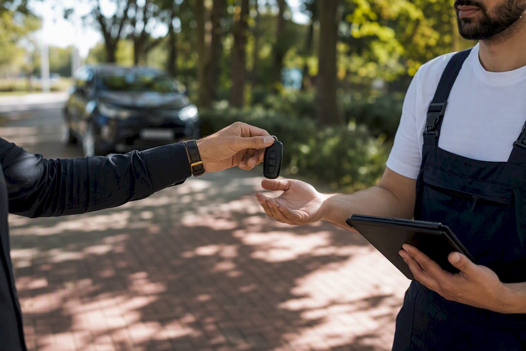 Hand passing car keys during inspection