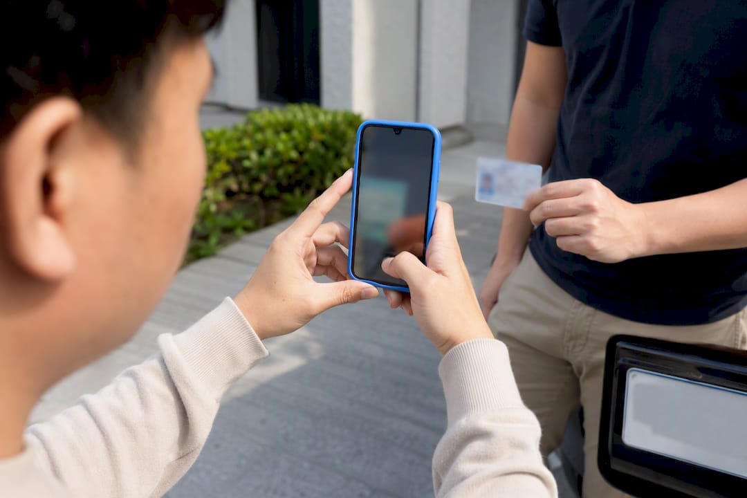 Seller photographing driver identification at pickup