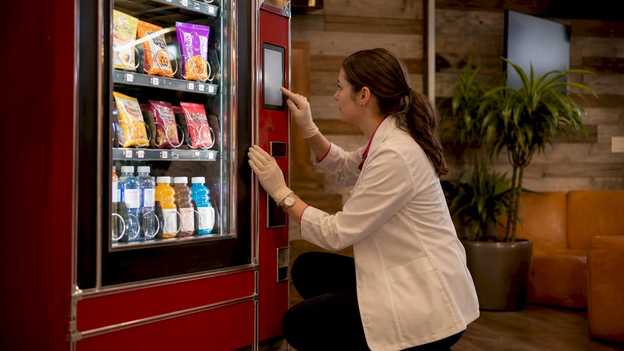 Hands using touchscreen on hospital vending machine