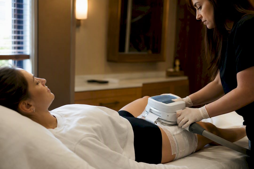 Patient undergoing CoolSculpting treatment on thigh