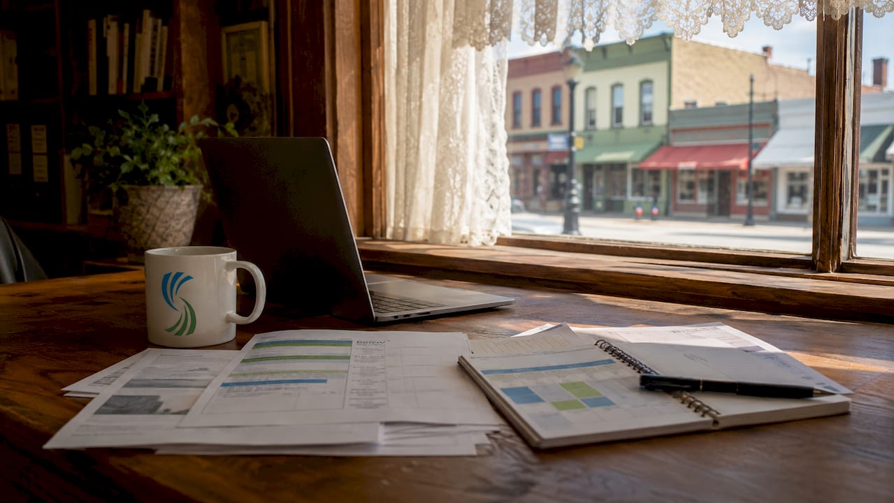 Laptop and papers on rural business desk