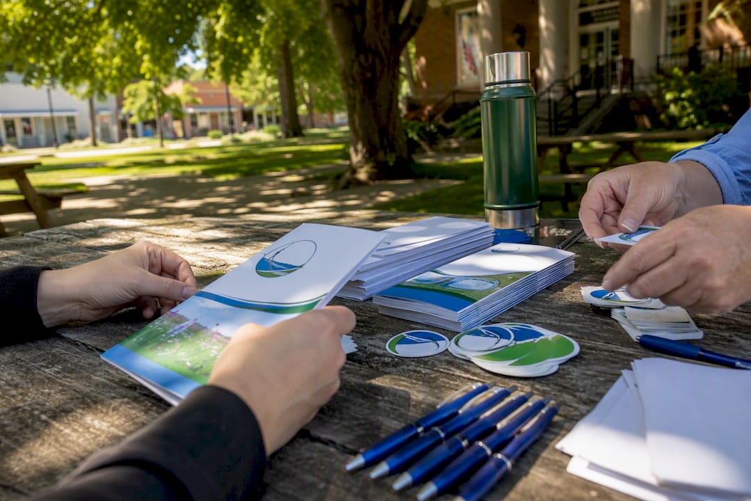 Hands preparing marketing media kit