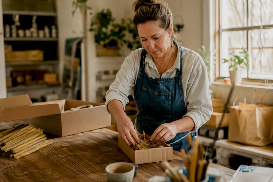 Small business owner arranging materials