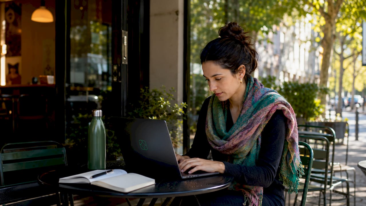 Hands typing rent collection data on laptop