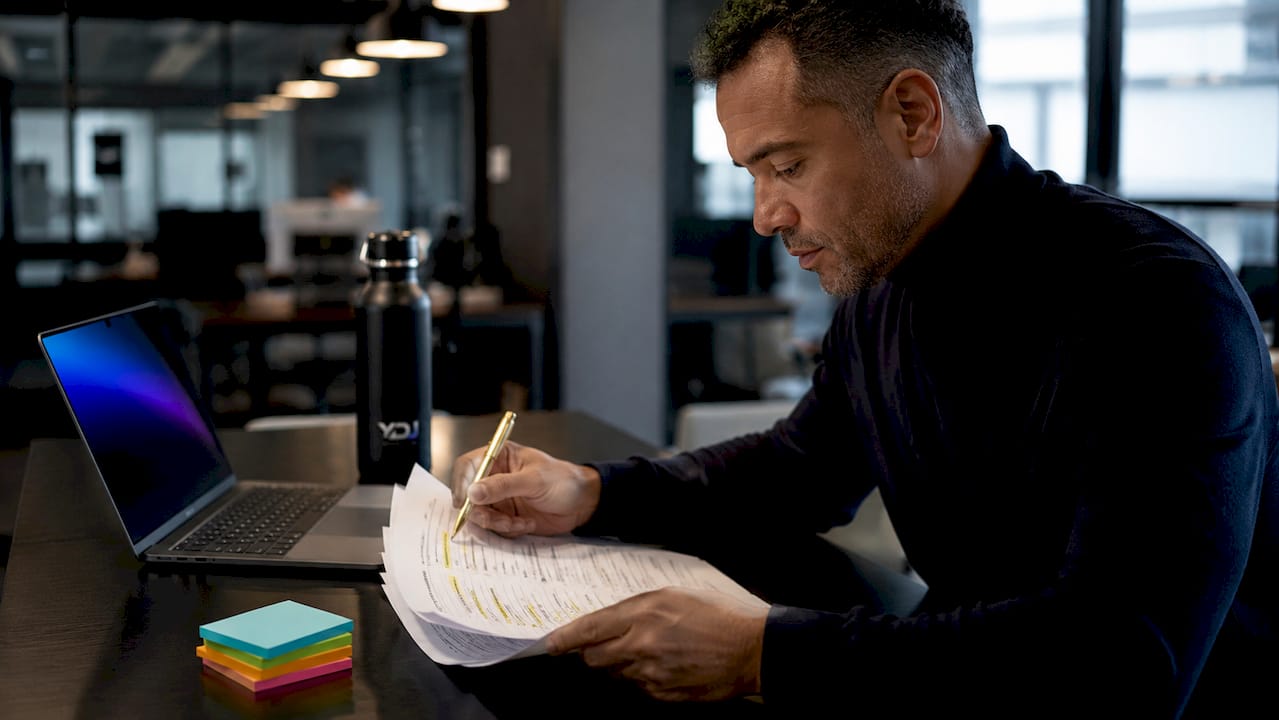 Hands reviewing printed customer feedback forms