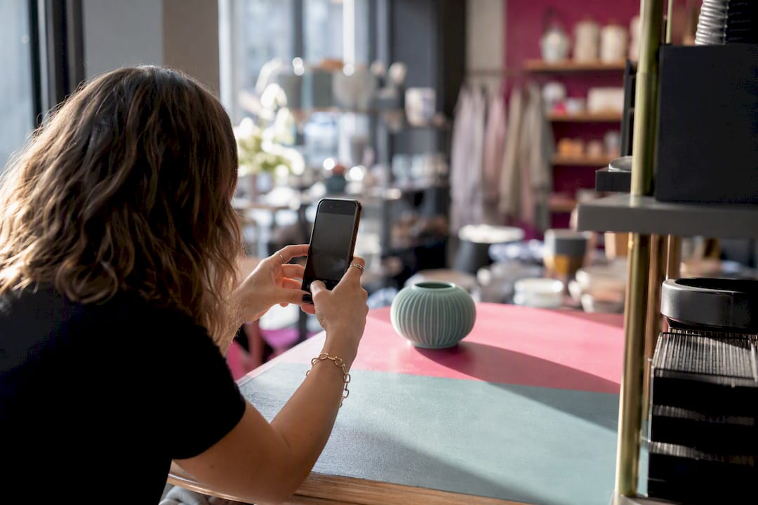 Hands photographing product for inventory listing