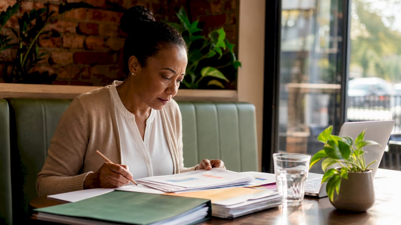 Bookkeeper reviewing financial documents at desk