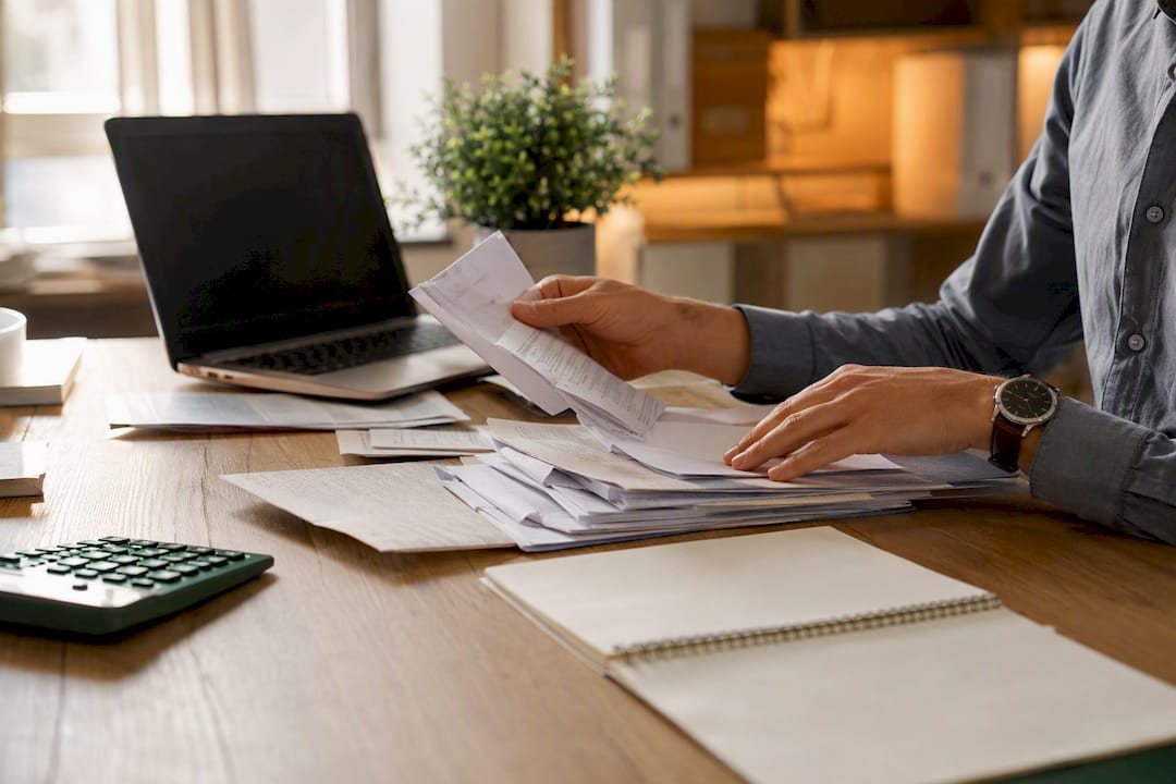 Hands sorting business asset tax documents
