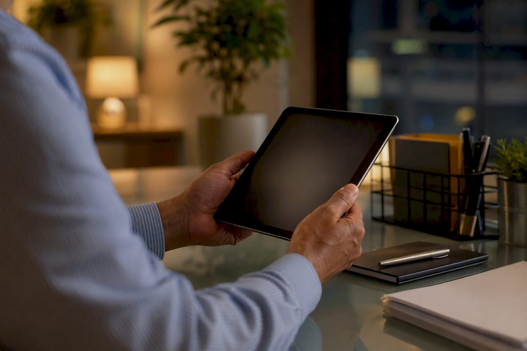 Hands inspecting tablet device