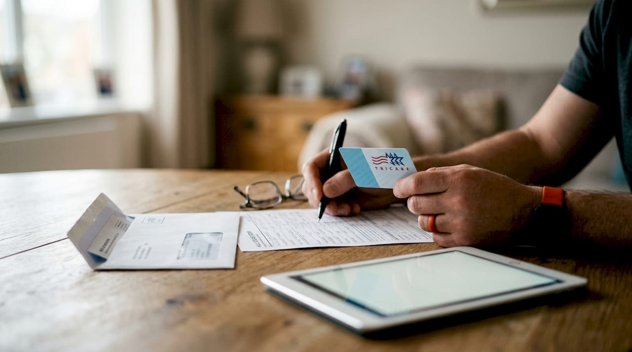 Hands managing TRICARE healthcare documents