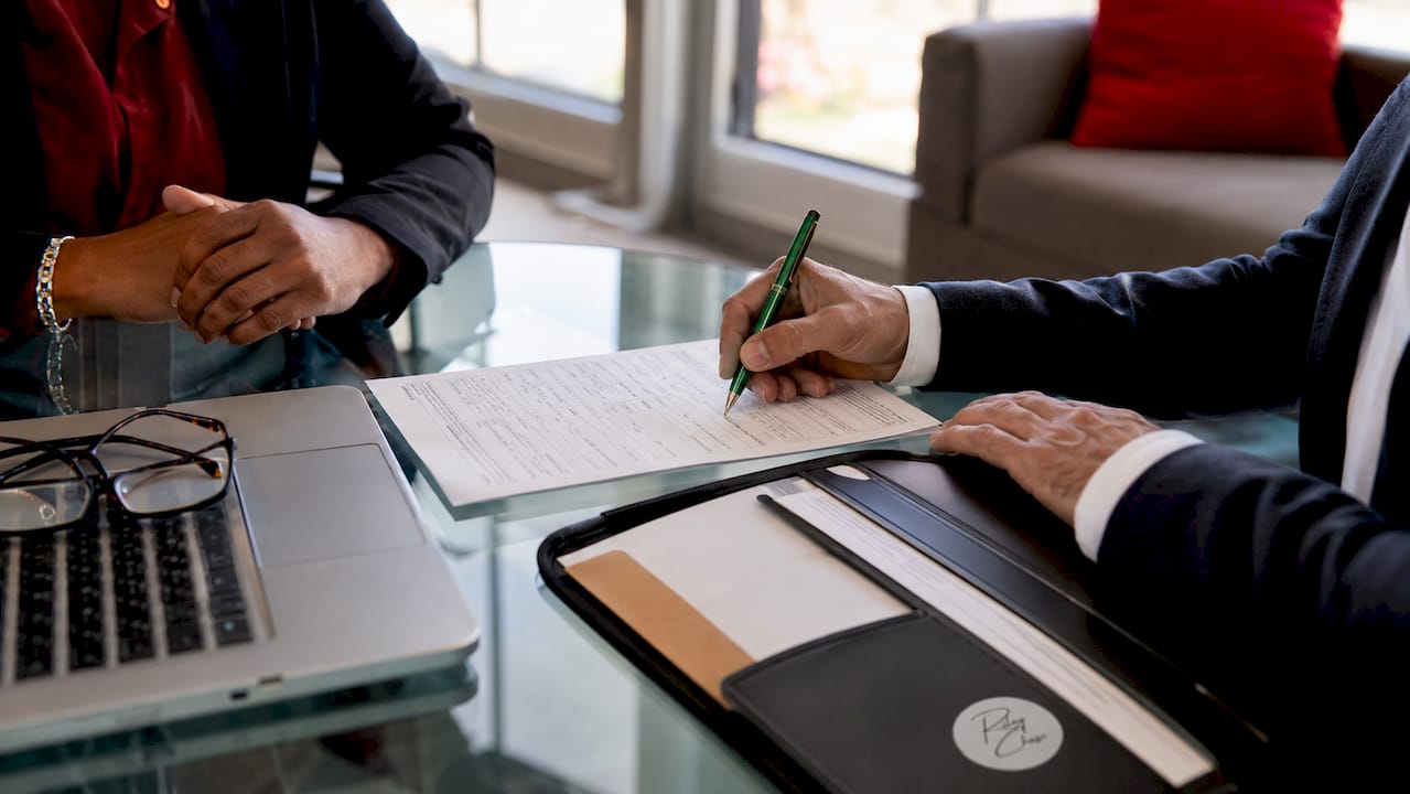 Close-up of hands completing mortgage loan application