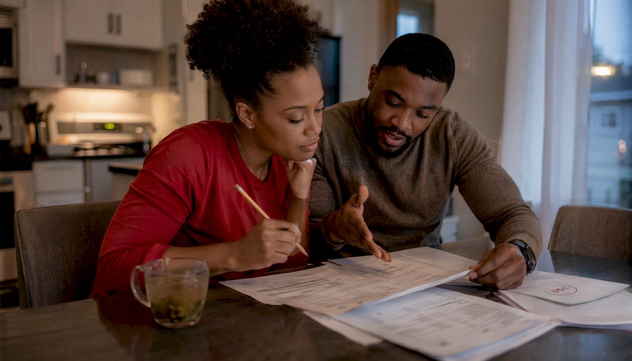 Couple discussing mortgage refinancing paperwork