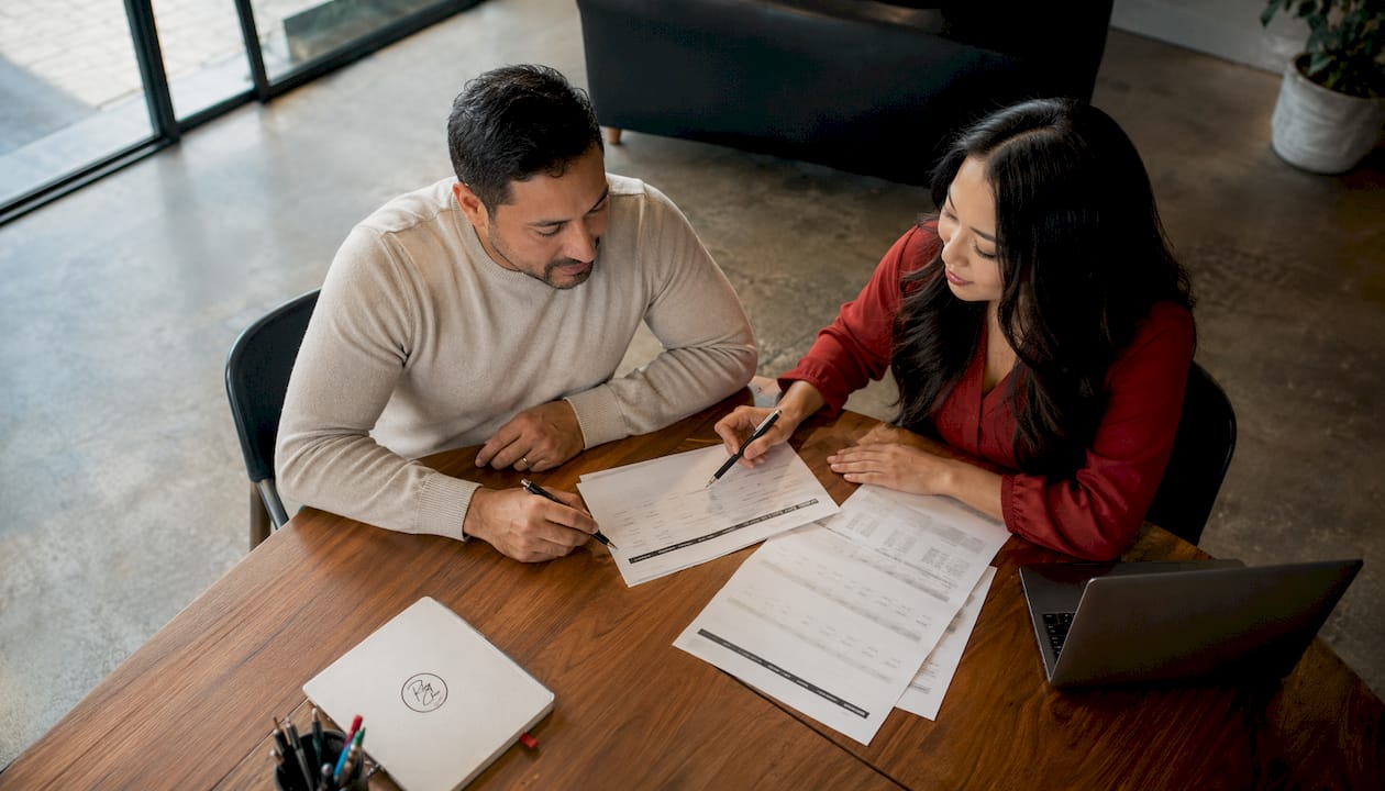 Two people discussing refinance loan options