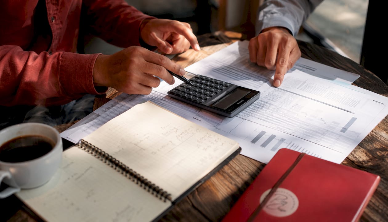 Hands calculating mortgage payments on desk