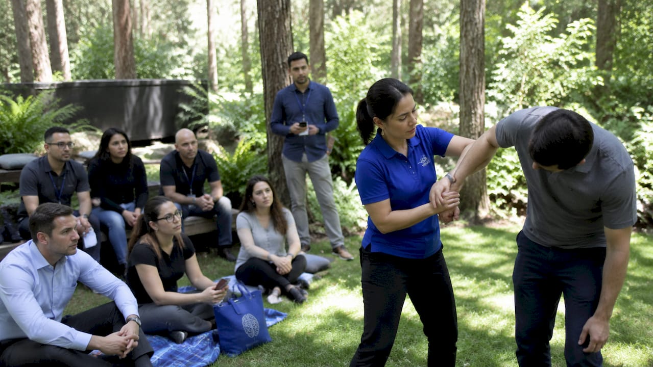 Employees learning self-defense from instructor