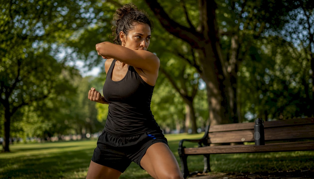 Woman practicing instinctive self-defense indoors