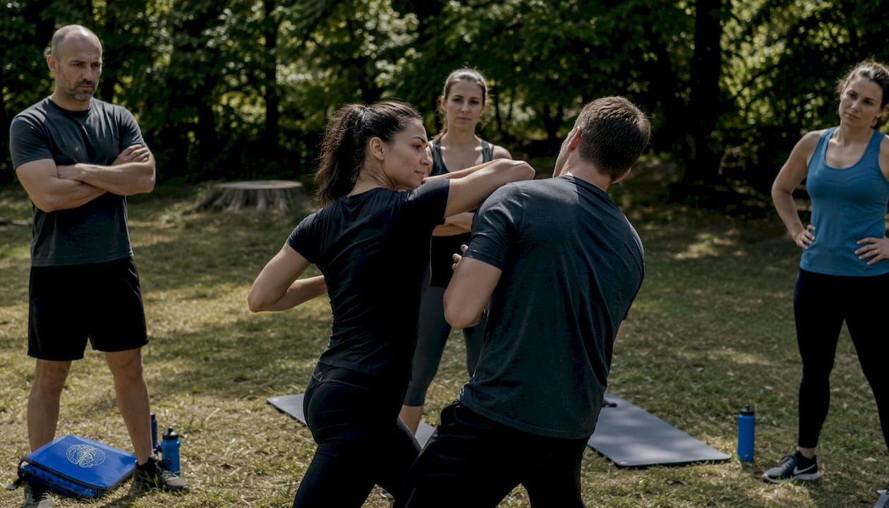 Instructor demonstrating self-defense move in dojo