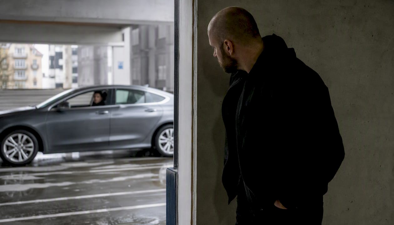 Individual observing parking garage for safety