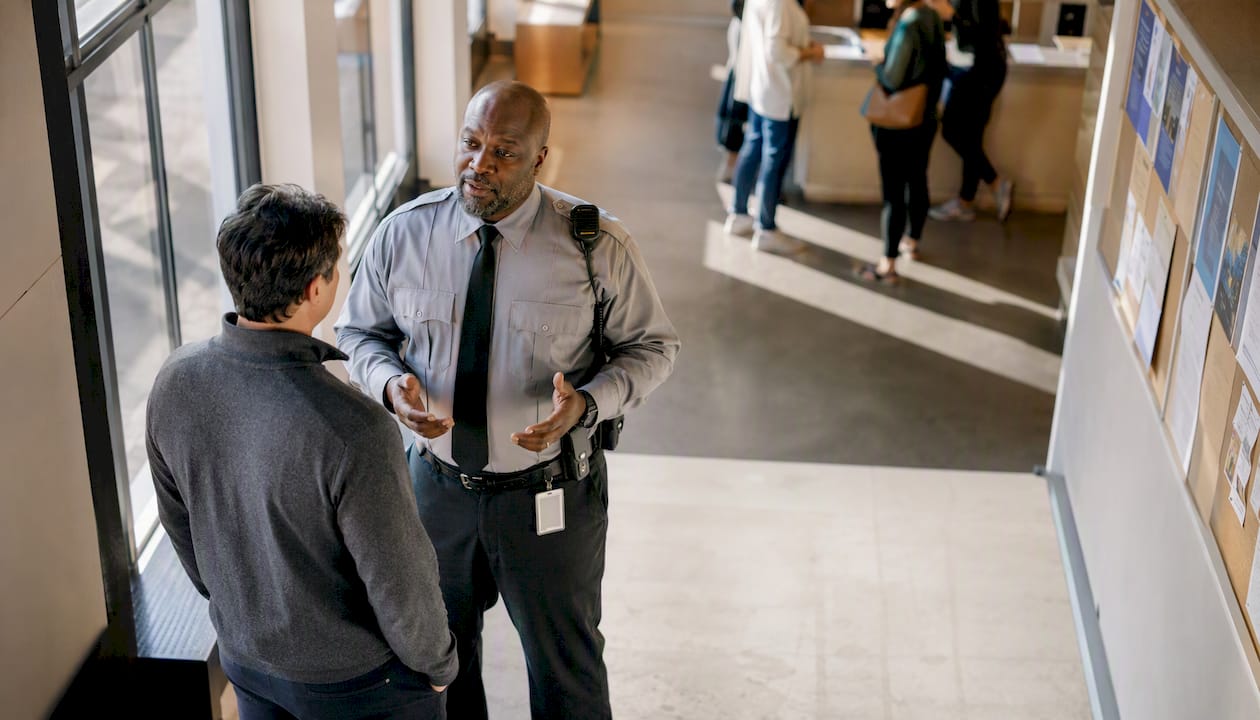 Hospital security officer redirecting visitor
