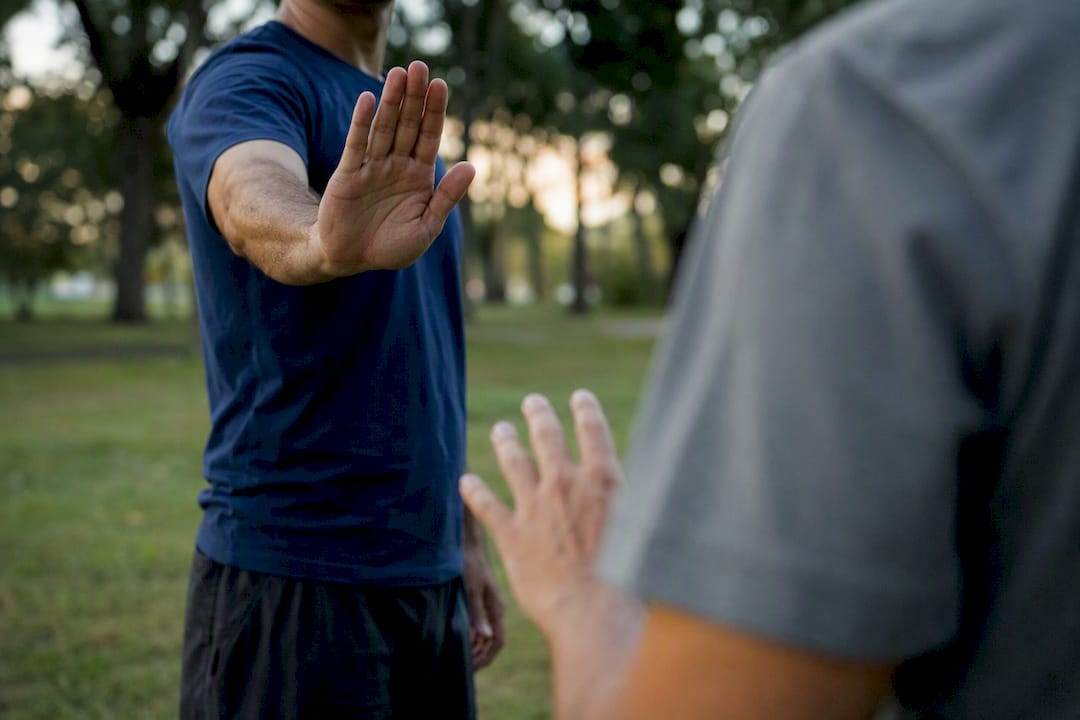 Person showing stop hand gesture in training room