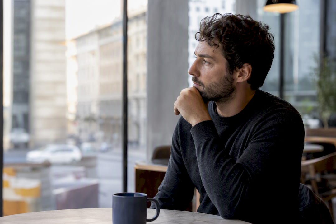 Person pausing thoughtfully in reflection