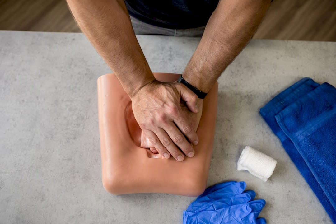 Trainee applying pressure during bleeding control