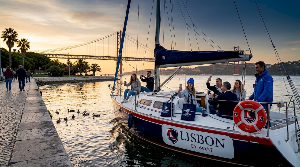 Sailboat cruising Tagus River with Lisbon landmarks