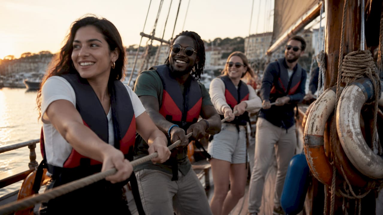 Group participating in heritage sailing tour on wooden boat