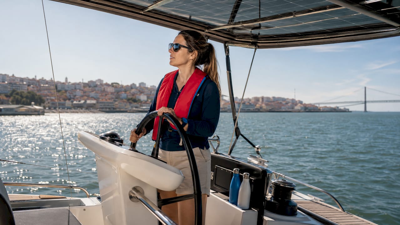 Captain steering sustainable sailing yacht