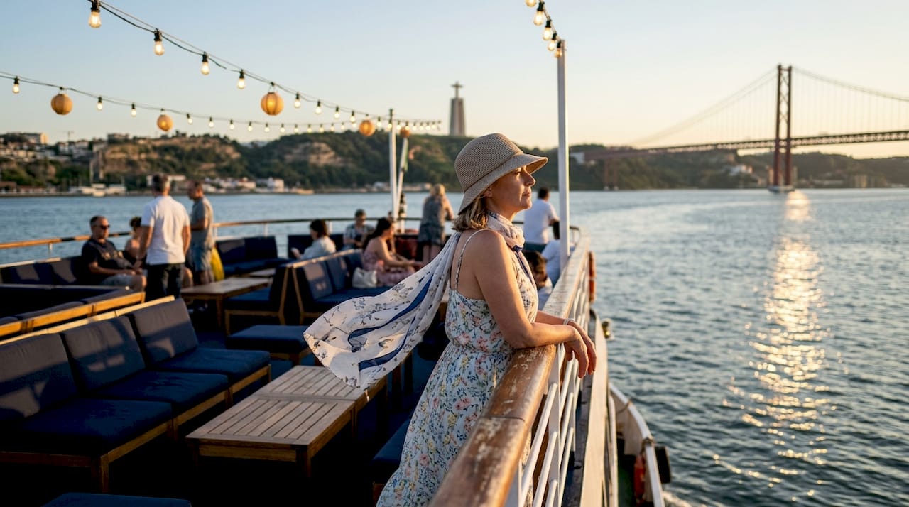 Tourist on boat admiring Lisbon river views