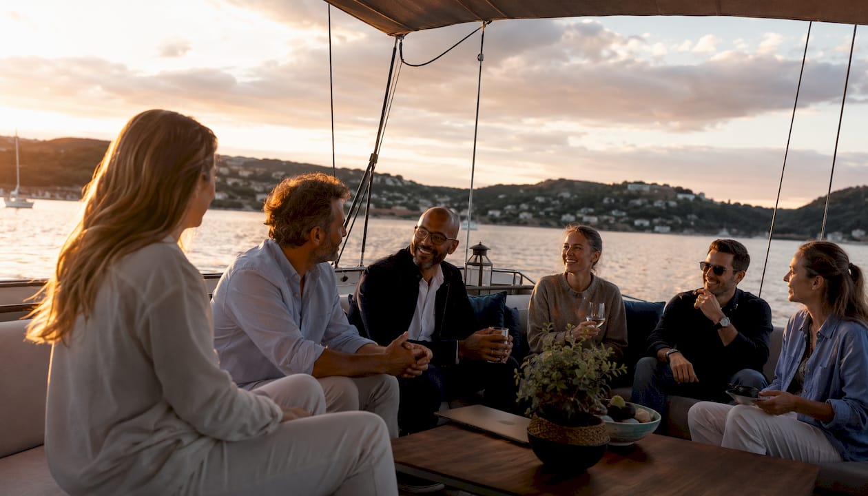 Corporate planners mingling on private sailing yacht deck