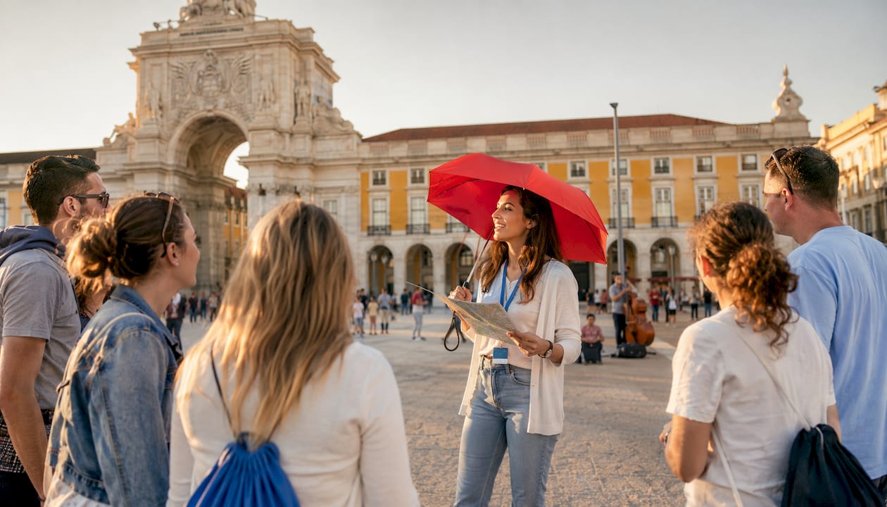 Tourists gathering at Rossio Square for walking tour