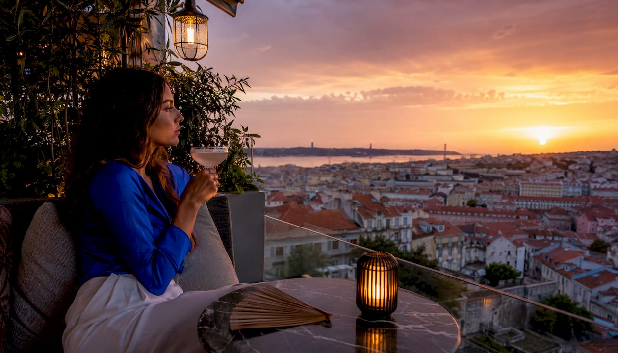 Woman enjoying sunset at Lisbon rooftop bar