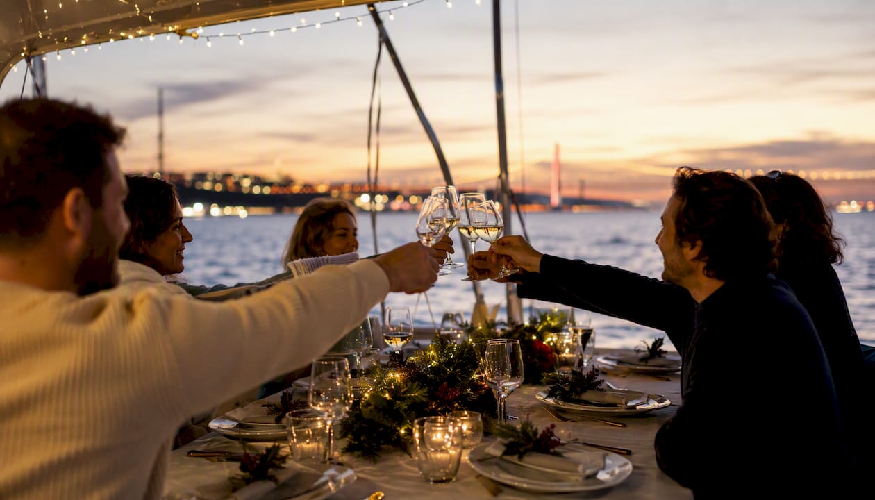 Christmas dinner table set on a yacht deck at sunset
