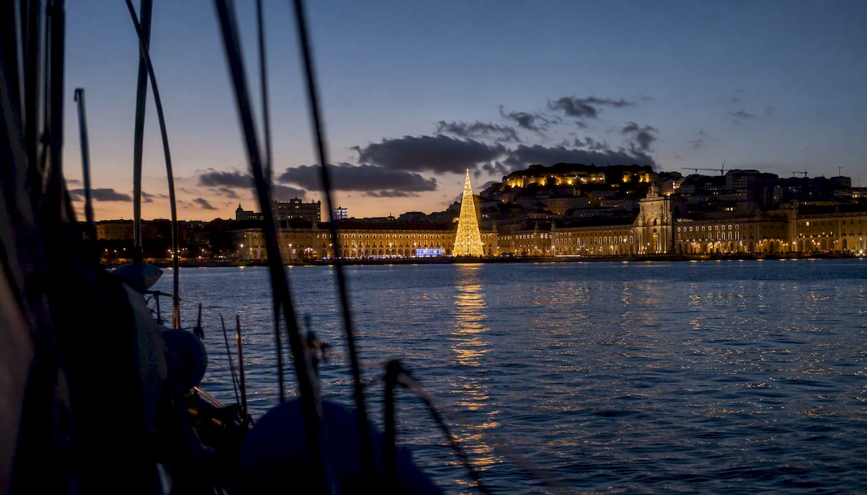 Christmas lights reflecting on Tagus River at night