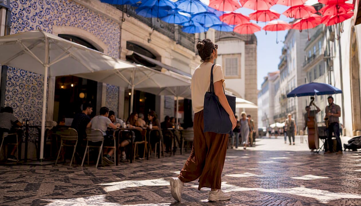 Person walking a narrow Alfama street in Lisbon