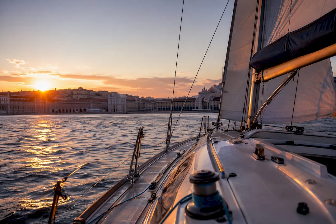 Sailing yacht on Tagus River at sunset