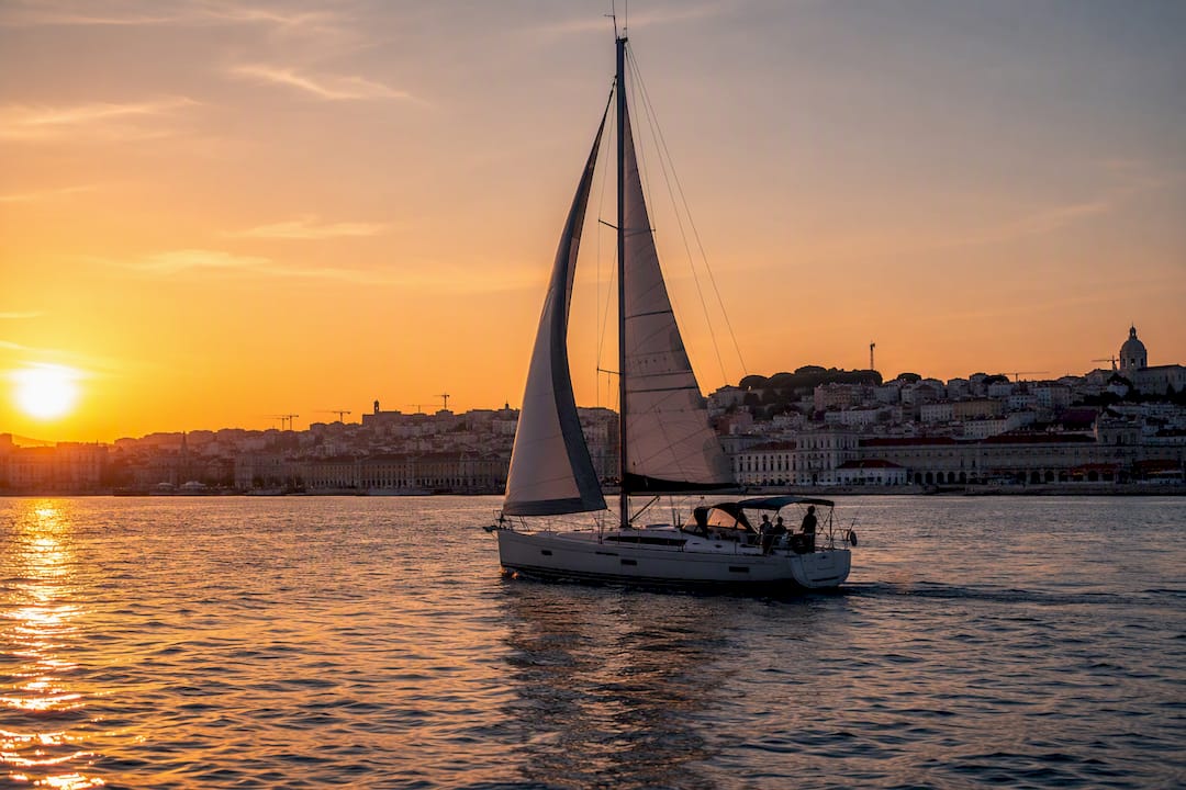 Sailing yacht on Tagus River at sunset