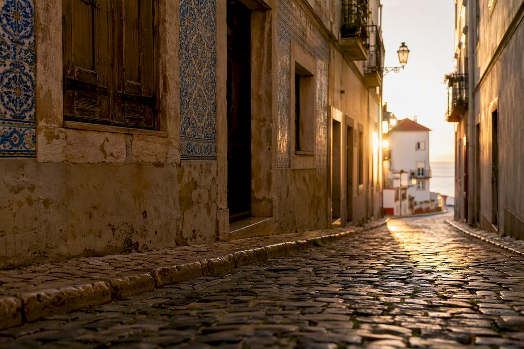 Sunrise light on Alfama street buildings