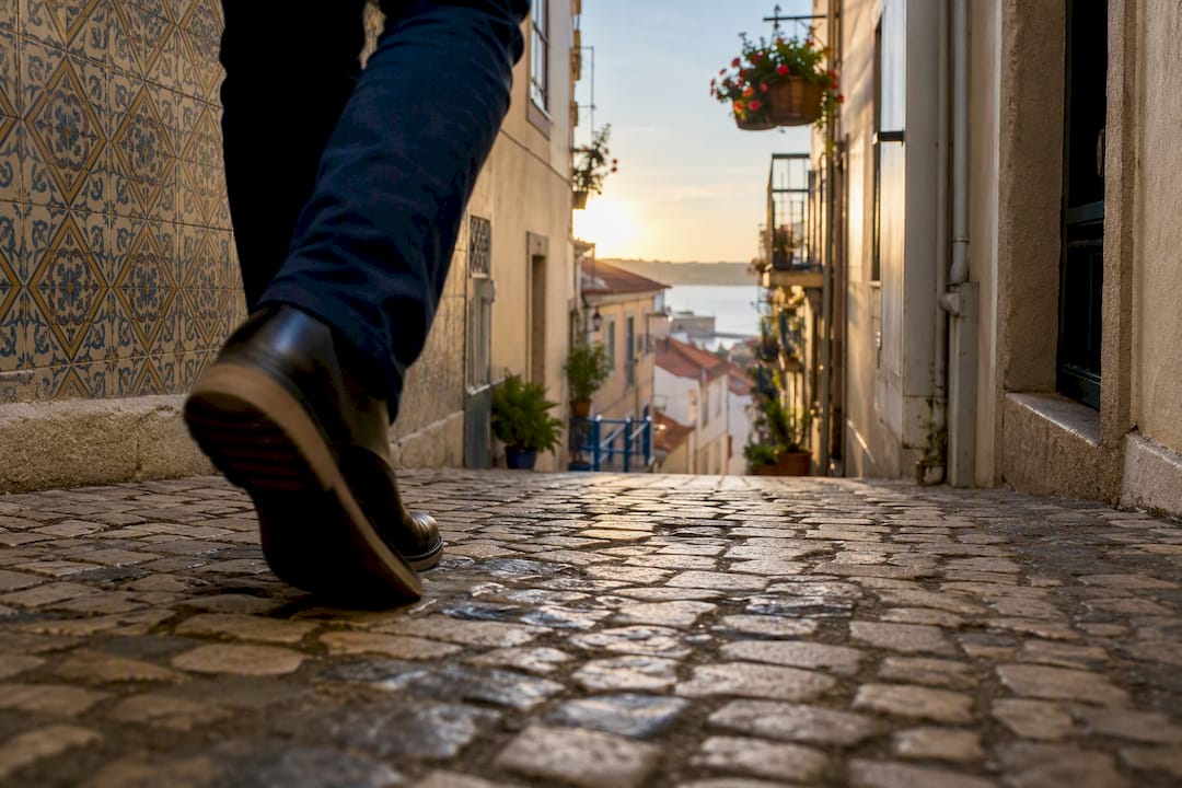 Tourist's walking shoes on Lisbon cobblestones