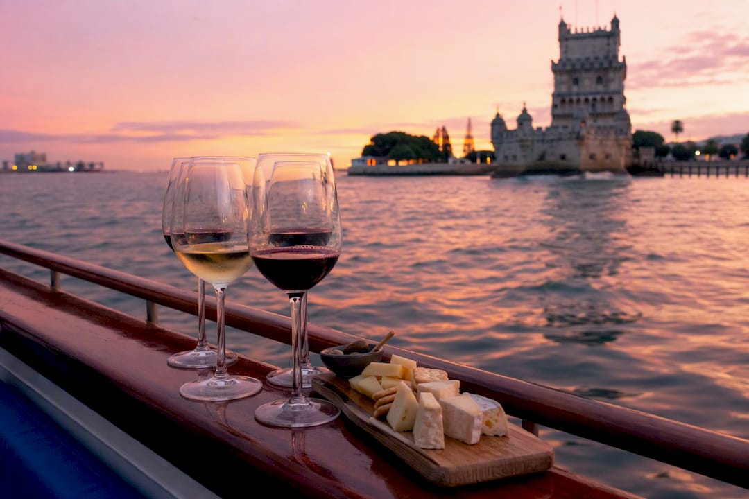 Wine glasses and cheese on sailboat at sunset