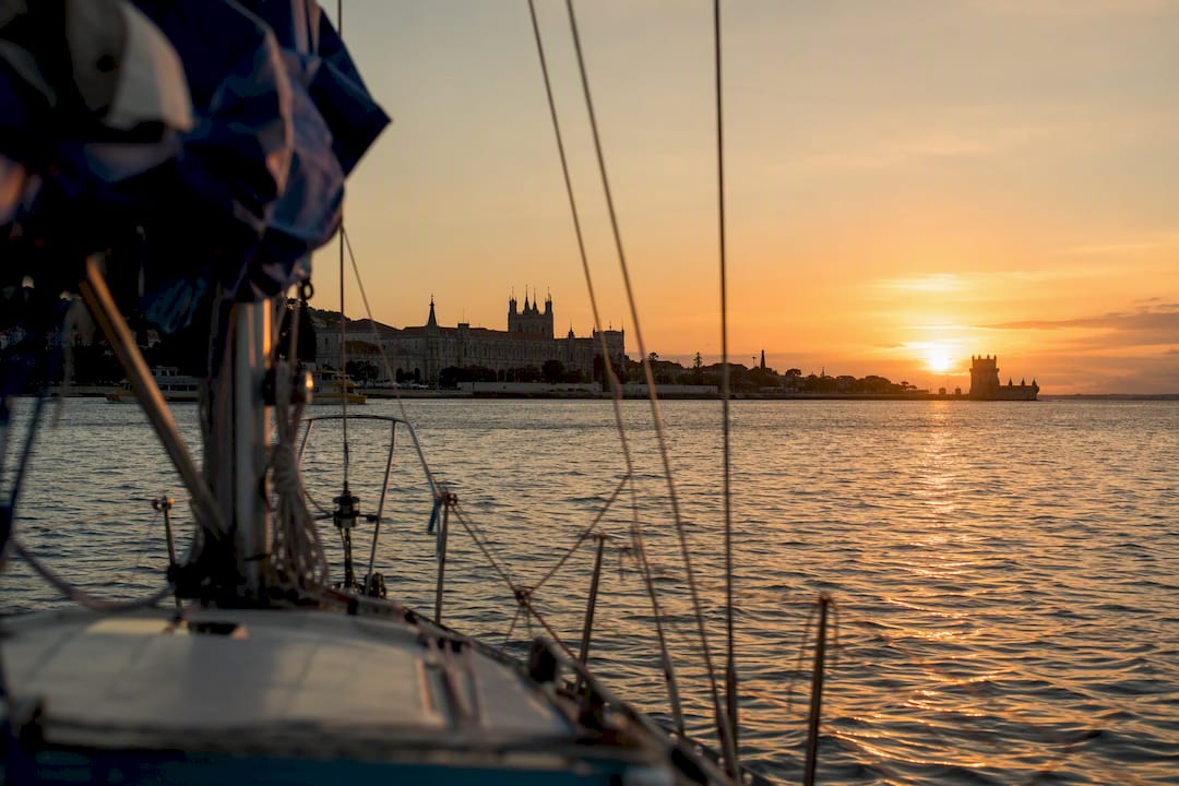 Sailing yacht bow on Tagus River at sunset