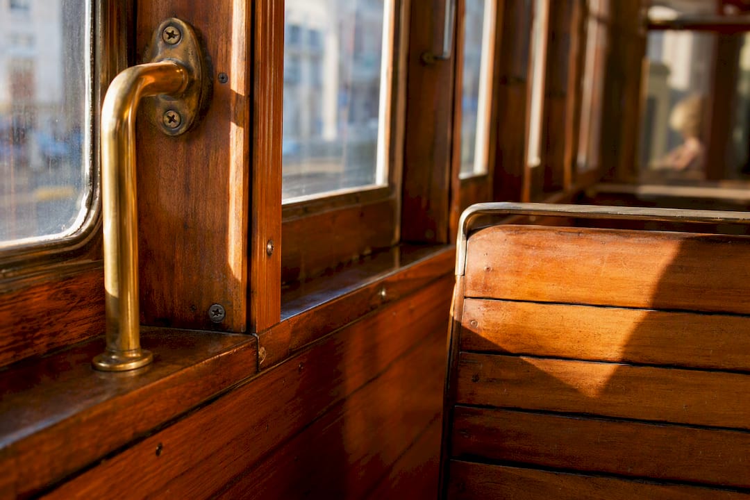 Wood paneling and brass fittings inside vintage tram