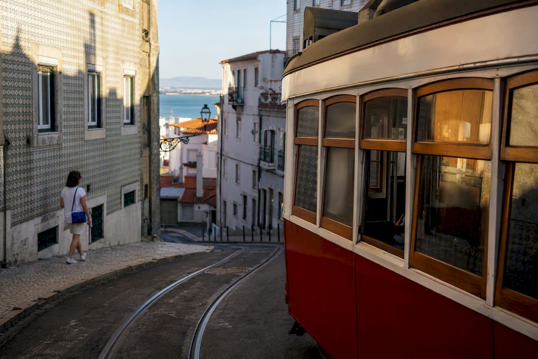 Tram turning through Lisbon’s Alfama streets
