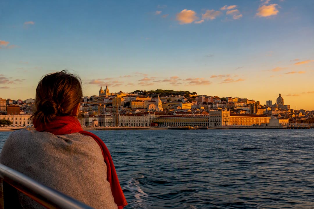 Lisbon skyline glowing above the Tagus at sunset