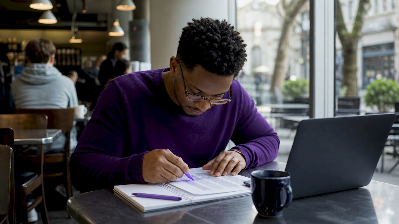 Graduate student reviewing research data in library